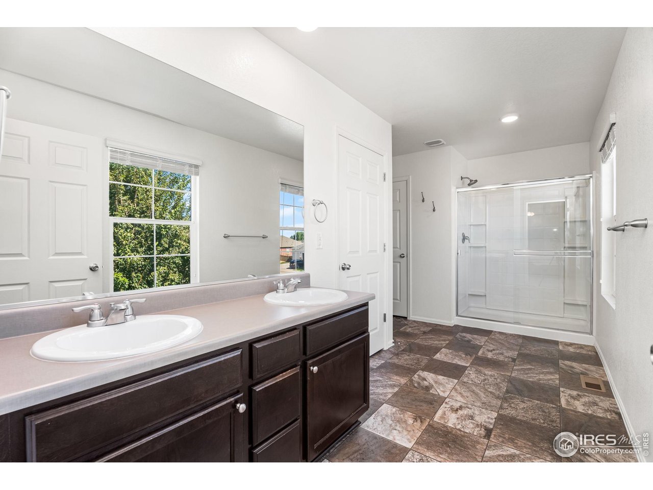 503 Buckrake Street Severance, CO 80550 - Photo 25 of 40 a bathroom with a sink shower and a mirror