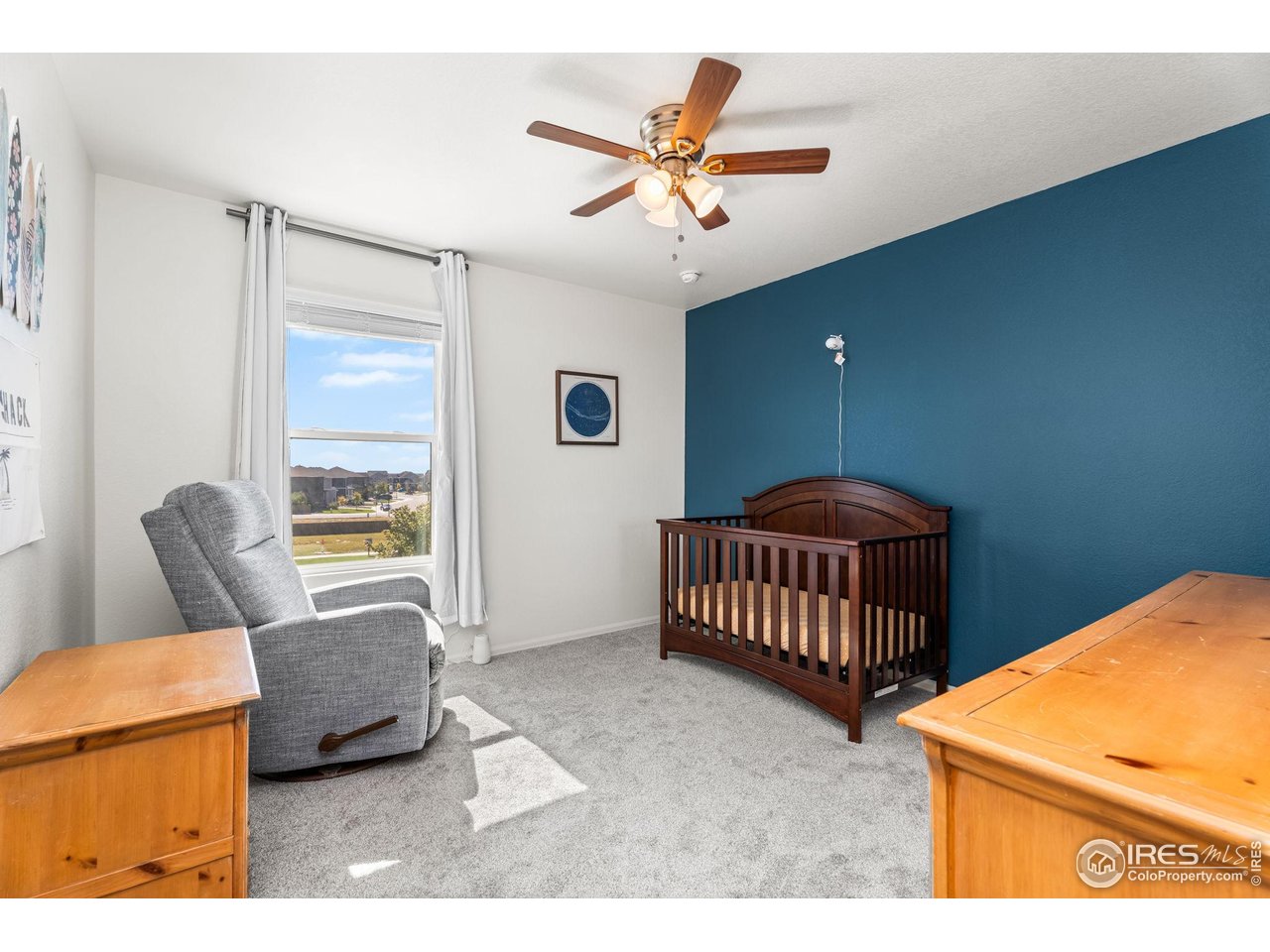 503 Buckrake Street Severance, CO 80550 - Photo 26 of 40 a bedroom with a bed a couch and a window