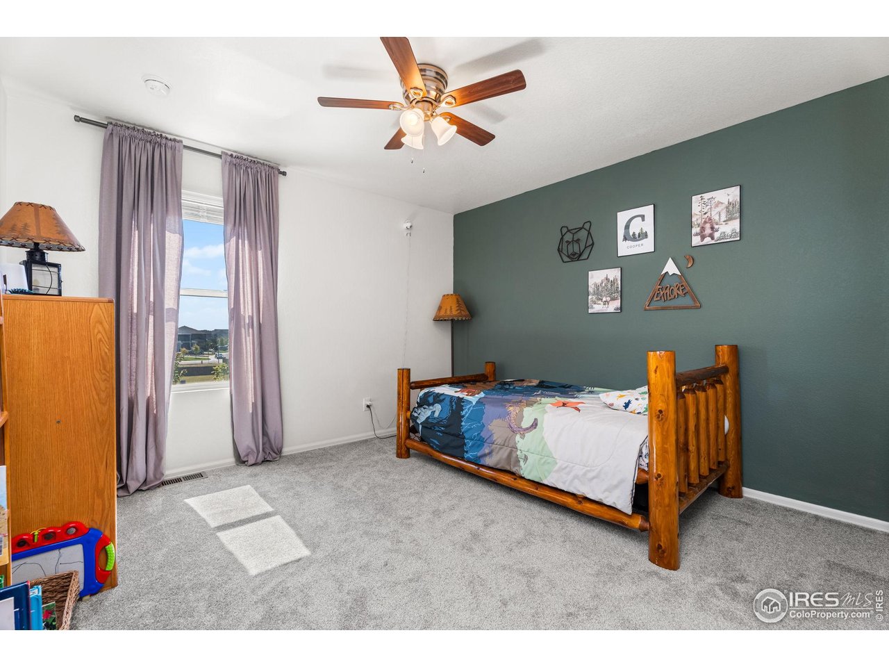 503 Buckrake Street Severance, CO 80550 - Photo 27 of 40 a bedroom with a bed and a chandelier