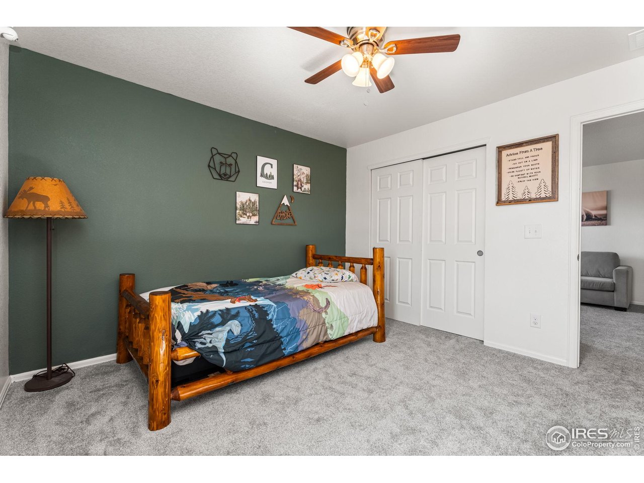 503 Buckrake Street Severance, CO 80550 - Photo 28 of 40 a bedroom with a bed and a chandelier