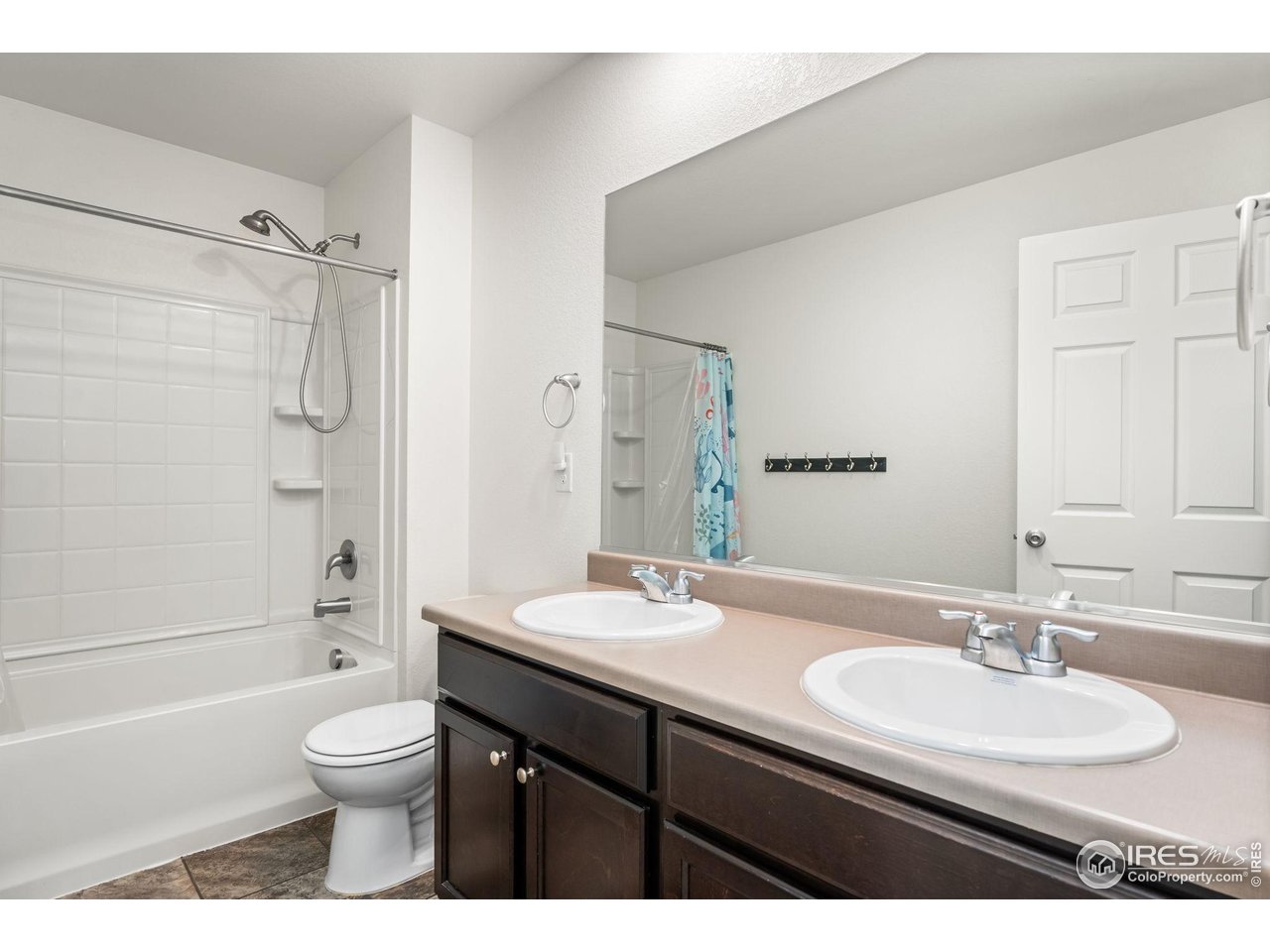 503 Buckrake Street Severance, CO 80550 - Photo 29 of 40 a bathroom with a granite countertop sink toilet a shower and a mirror