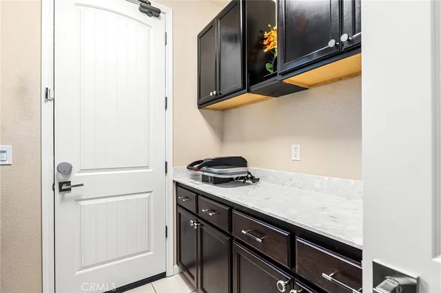 a view of a chair and table in the back yard of the house