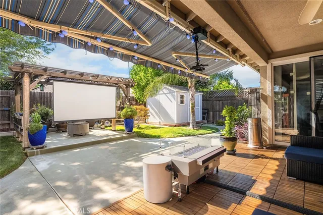 a view of a patio with table and chairs potted plants