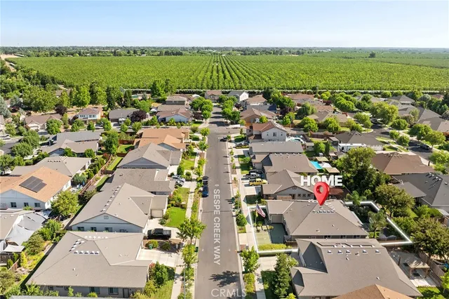 an aerial view of residential houses with outdoor space and swimming pool
