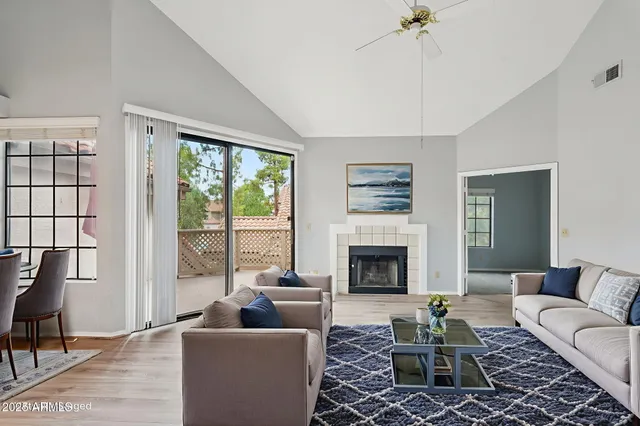 wooden floor fireplace and windows in an empty room
