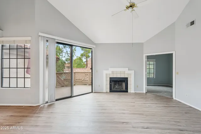 a large kitchen with granite countertop a stove a sink and a wooden floor