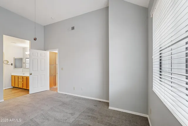 a spacious bathroom with a double vanity sink and a mirror