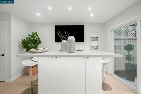 a kitchen with stainless steel appliances a sink and a white cabinets
