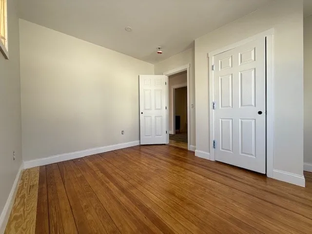 a view of an empty room and wooden floor