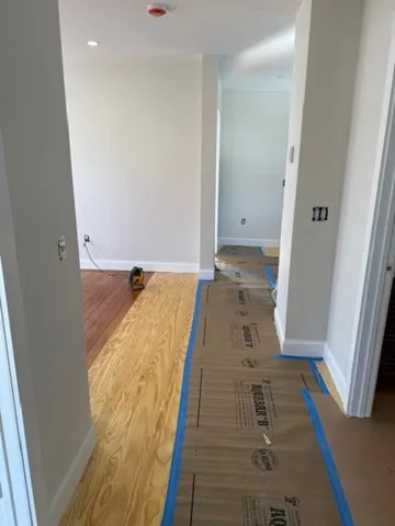 a view of hallway with wooden floor