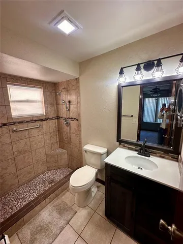 a bathroom with a sink toilet a mirror and shower