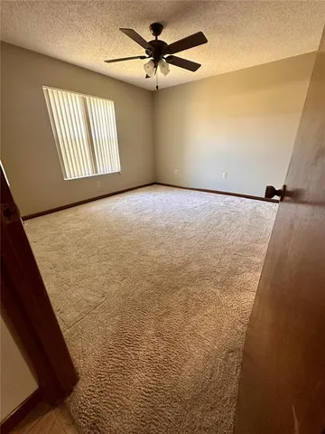 a view of a livingroom with a ceiling fan and window