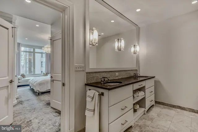 a bathroom with a double vanity sink and mirror
