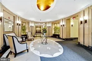 a view of a livingroom with furniture and floor to ceiling window