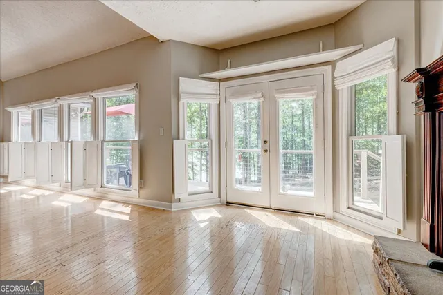 a large kitchen with stainless steel appliances a stove refrigerator and a fireplace