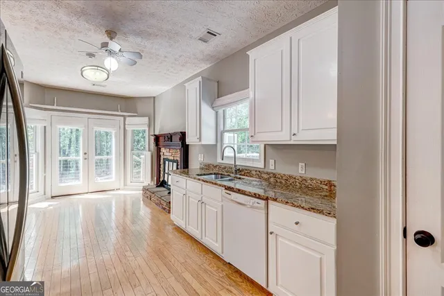 a kitchen with stainless steel appliances a refrigerator sink and cabinets