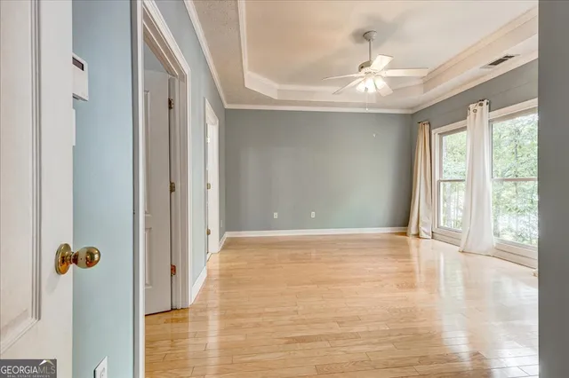 a view of an empty room and wooden floor