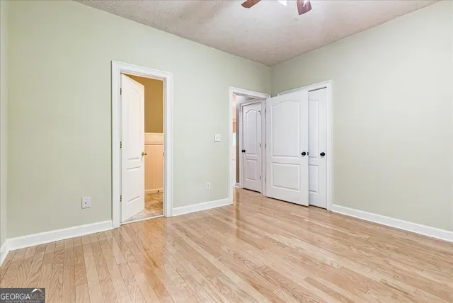 an empty room with kitchen view