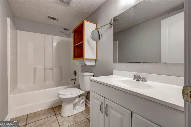 a view of a hallway with stainless steel appliances