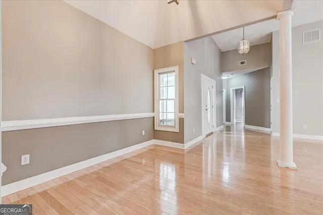 wooden floor in an empty room with a window