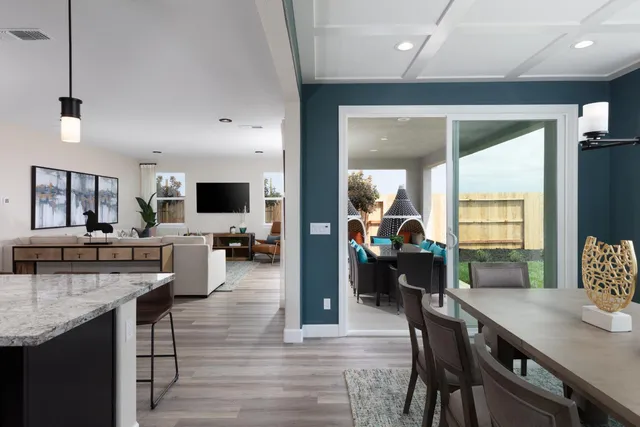 a kitchen with counter top space and wooden floor
