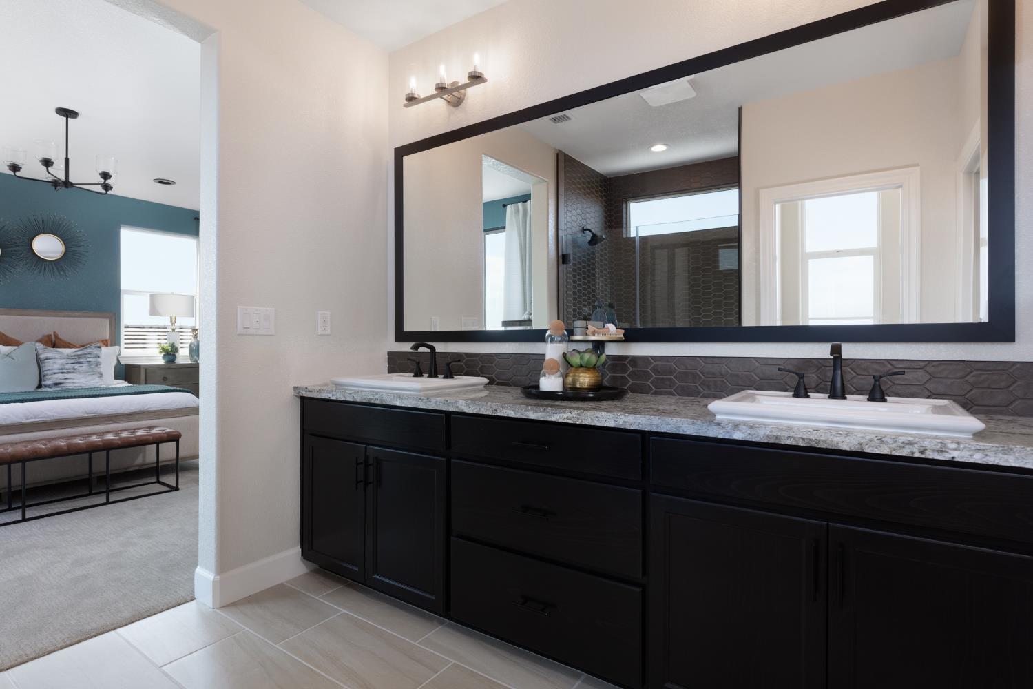12708 Castaic Lk Way Rancho Cordova, CA 95742 - Photo 8 of 10 a bathroom with double vanity sinks and a mirror
