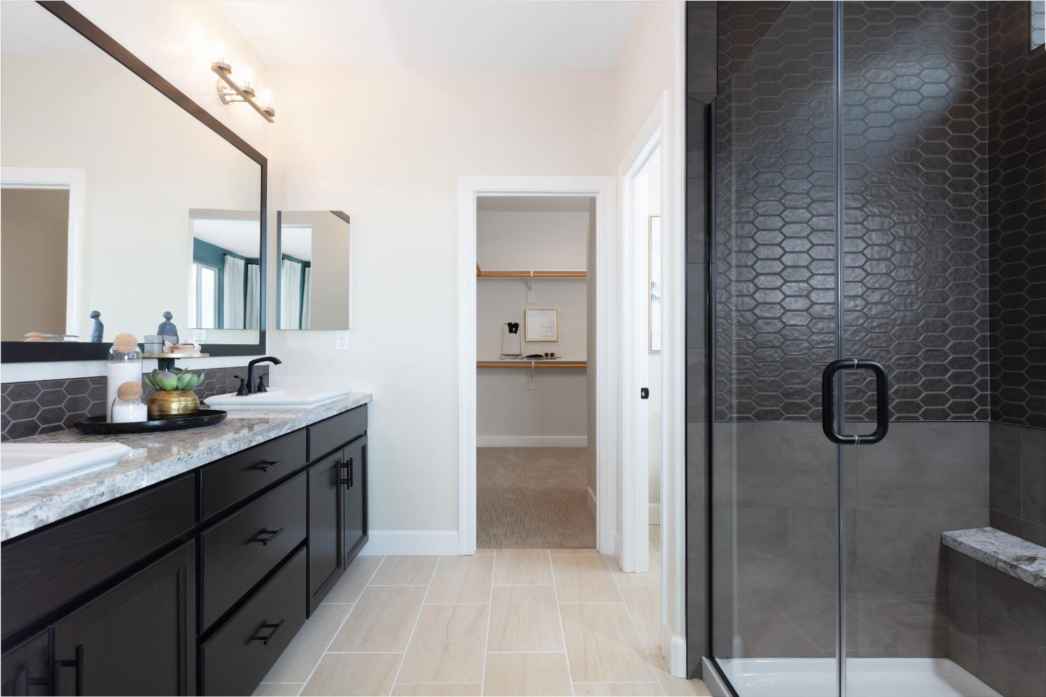12708 Castaic Lk Way Rancho Cordova, CA 95742 - Photo 9 of 10 a bathroom with a double vanity sink a mirror and shower