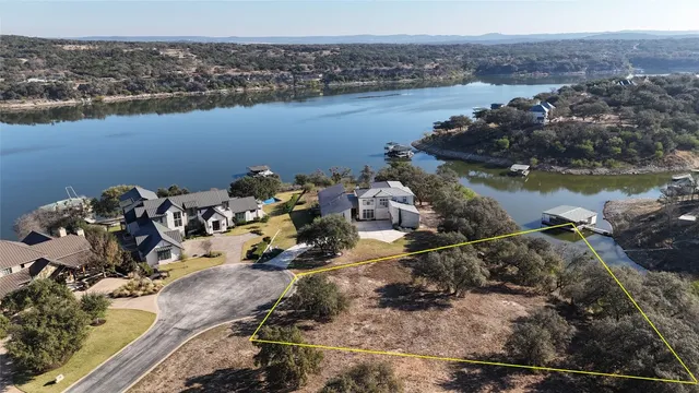 an aerial view of a house with a lake view