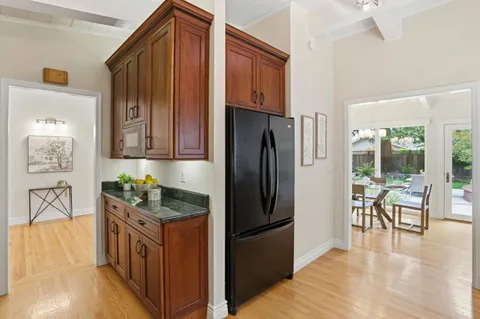 a view of a dining room with furniture a chandelier and wooden floor