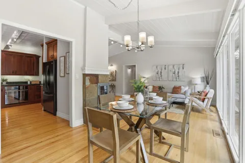 a view of a dining room with furniture and chandelier
