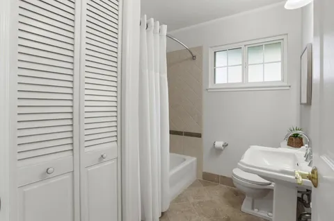 a bathroom with a sink a mirror and a toilet