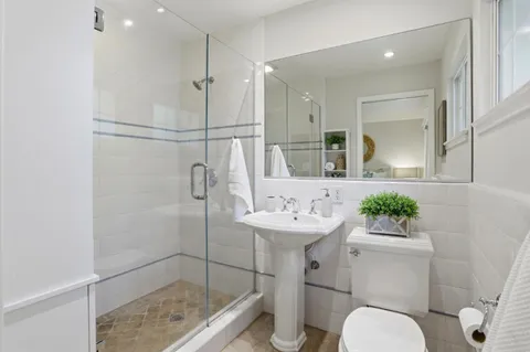 a white toilet sitting next to a bathroom sink