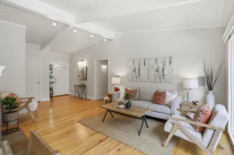 a living room with fireplace furniture and a fireplace