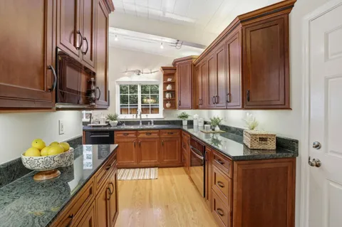 a kitchen with stainless steel appliances granite countertop a stove and a sink