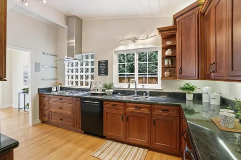 a kitchen with stainless steel appliances granite countertop a refrigerator and a stove top oven
