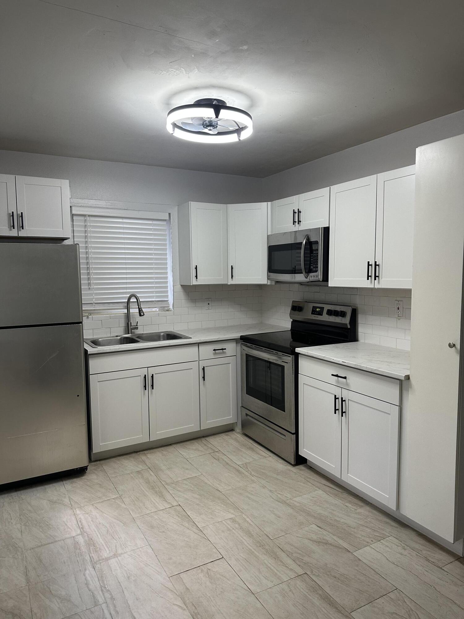 a kitchen with a refrigerator stove and microwave
