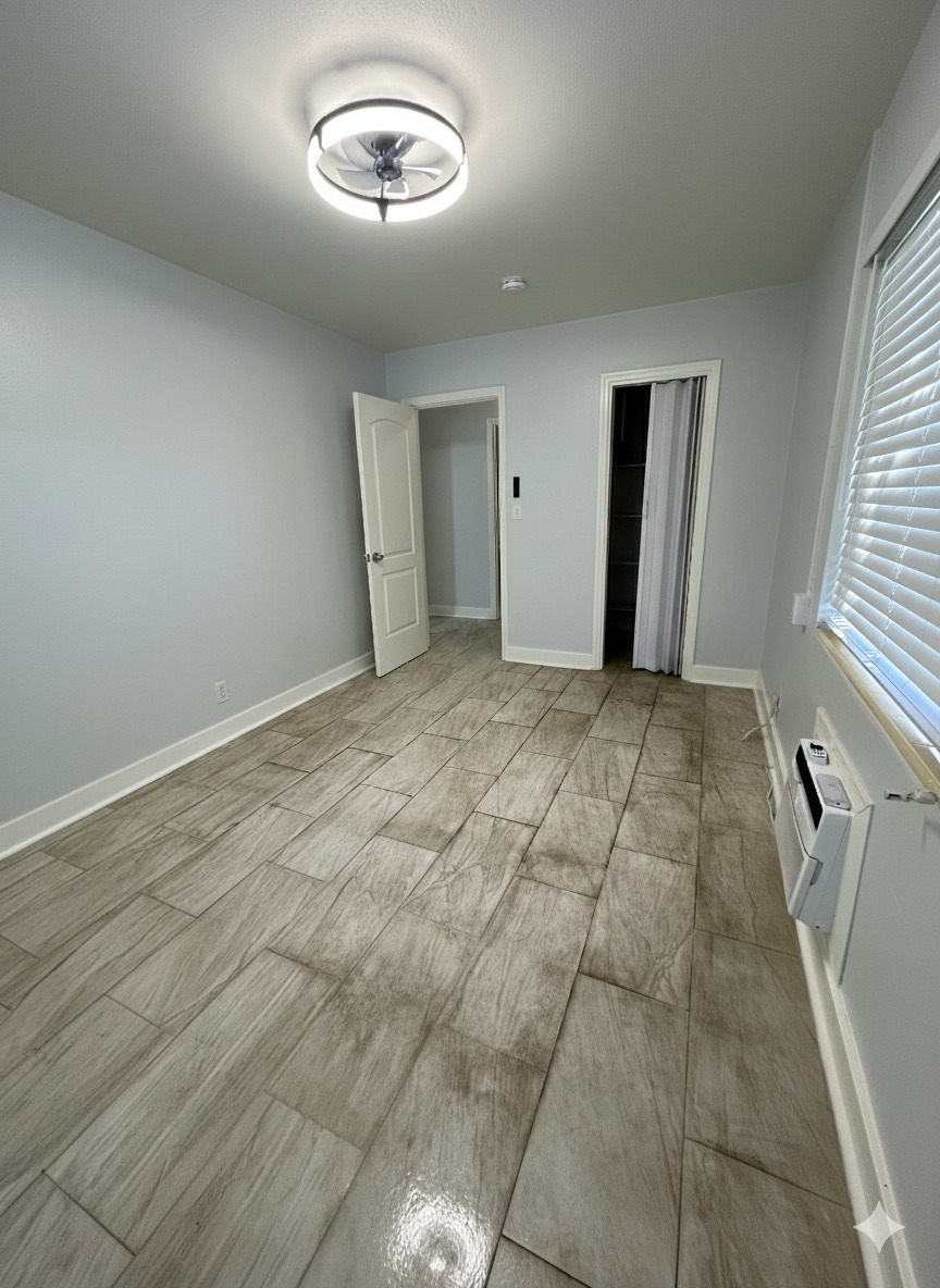 178 East 27th Street, Unit 3 Riviera Beach, FL 33404 - Photo 5 of 8 an empty room with a fireplace