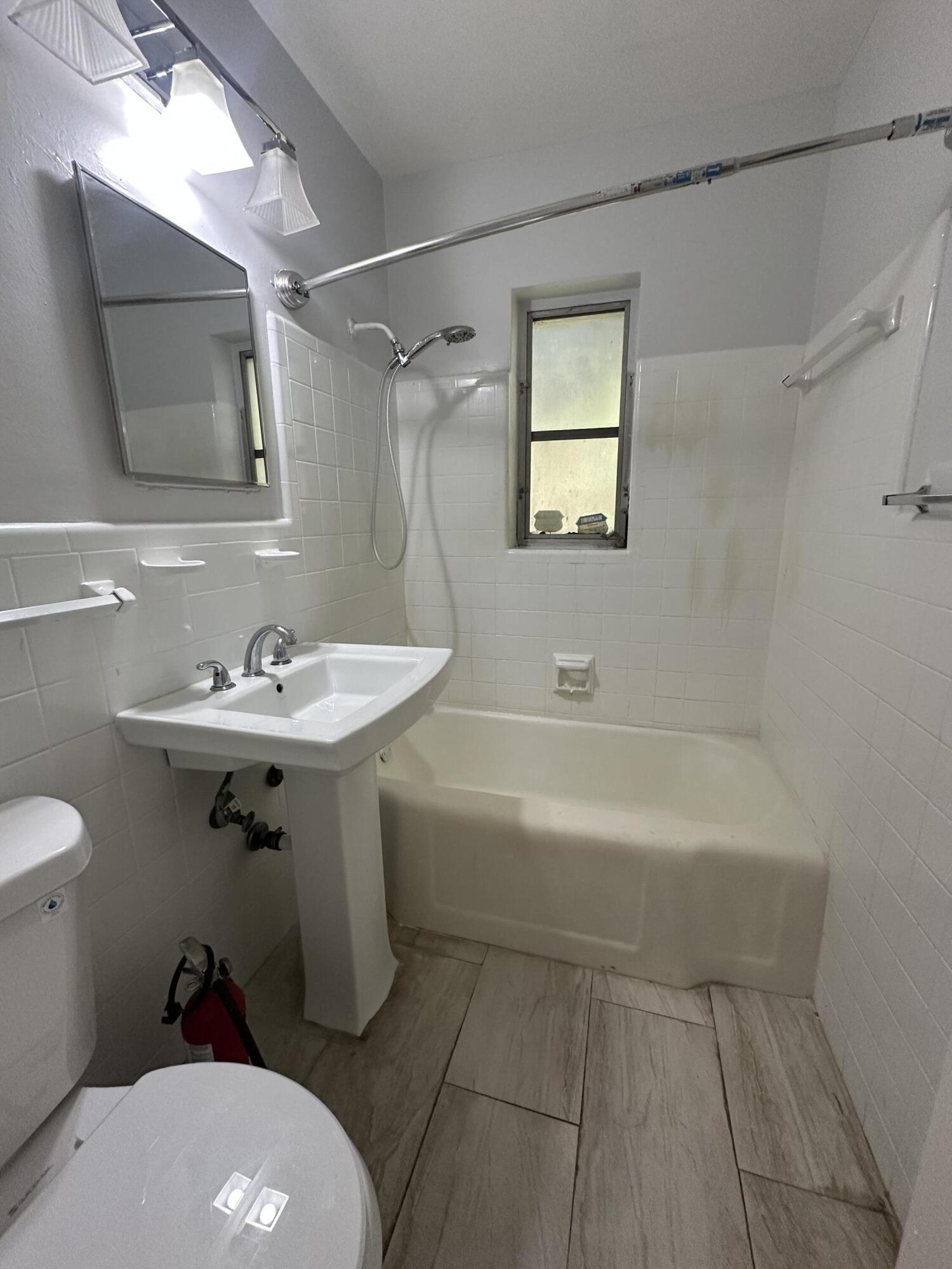 178 East 27th Street, Unit 3 Riviera Beach, FL 33404 - Photo 7 of 8 a bathroom with a sink toilet and shower