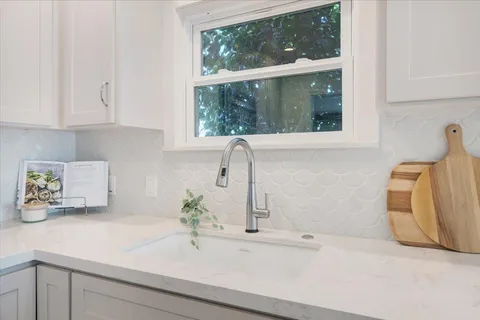 a bathroom with a sink and a window