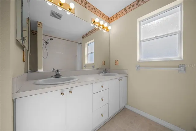 a view of an empty room with a ceiling fan