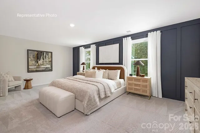 a spacious bedroom with a large bed and a window