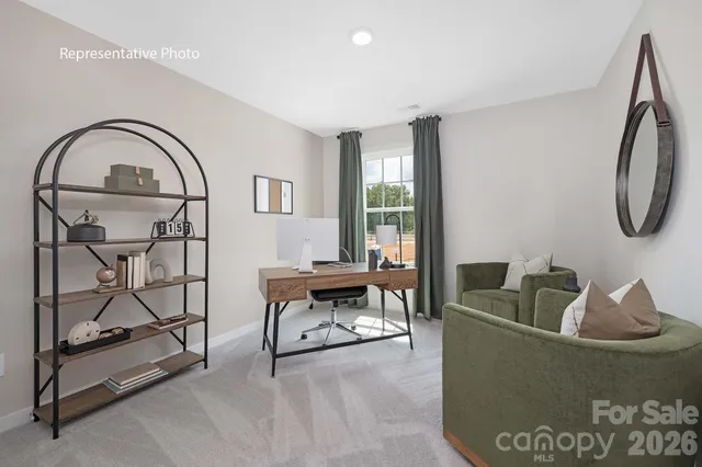 a living room with furniture a window and a potted plant