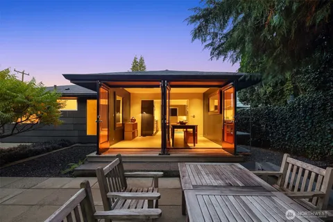 a view of a house with backyard and porch