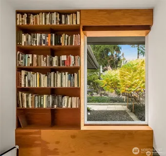 a living room with furniture fireplace and window