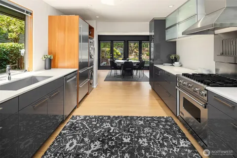 a large kitchen with kitchen island granite countertop a large window