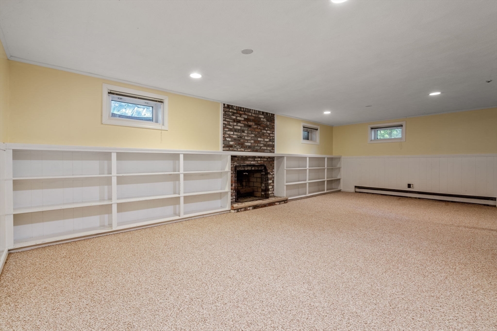 21 Pawnee Circle Milton, MA 02186 - Photo 12 of 17 a view of an empty room with a fireplace