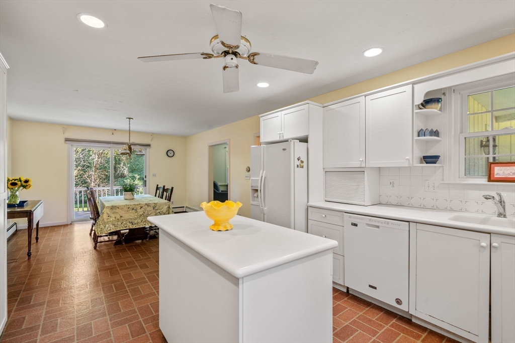 21 Pawnee Circle Milton, MA 02186 - Photo 10 of 17 a kitchen with a sink dishwasher and white cabinets with wooden floor
