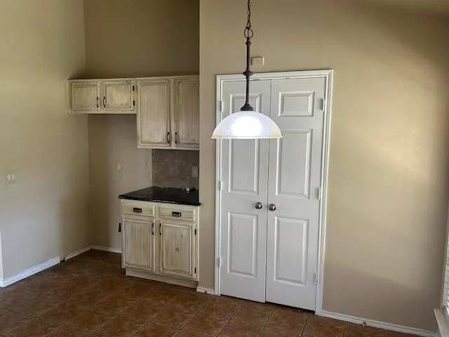 an empty room with a kitchen