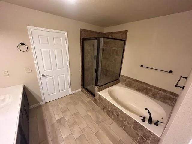 a bathroom with a tub and shower