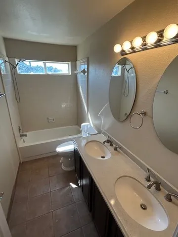 a bathroom with a double vanity sink and a mirror